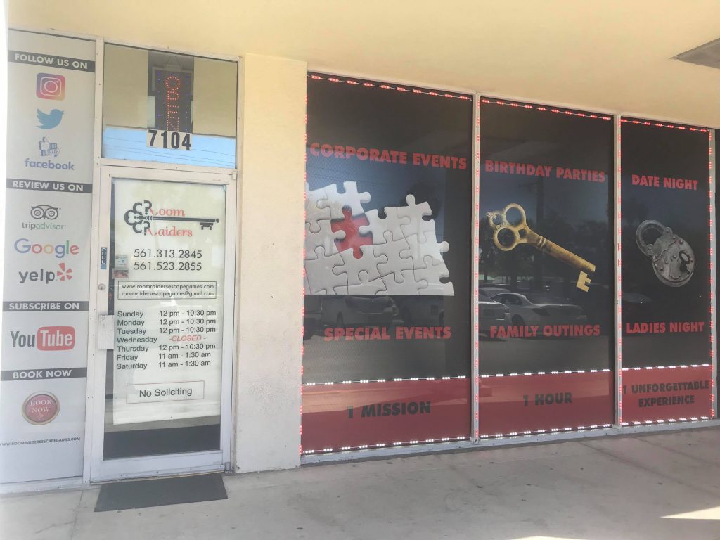 A window display of a key and puzzle piece.