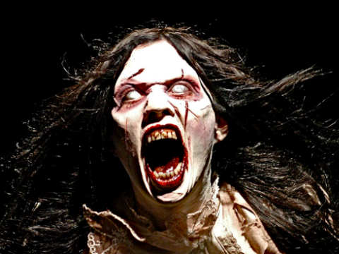 A woman with long hair and bloody teeth.