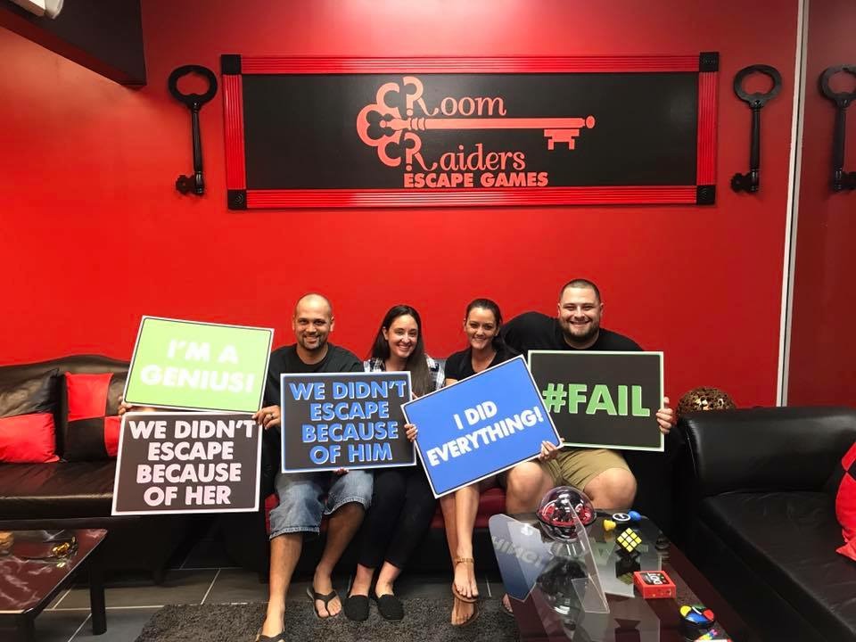 A group of people holding signs in front of a room.