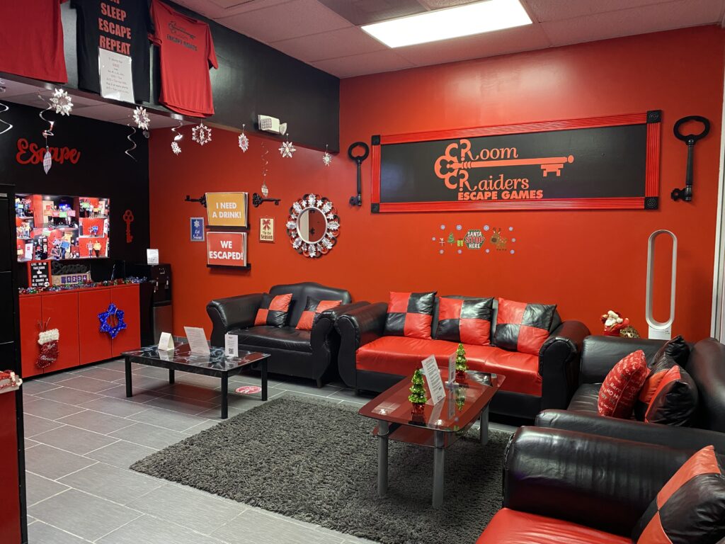 A room with red walls and black furniture.