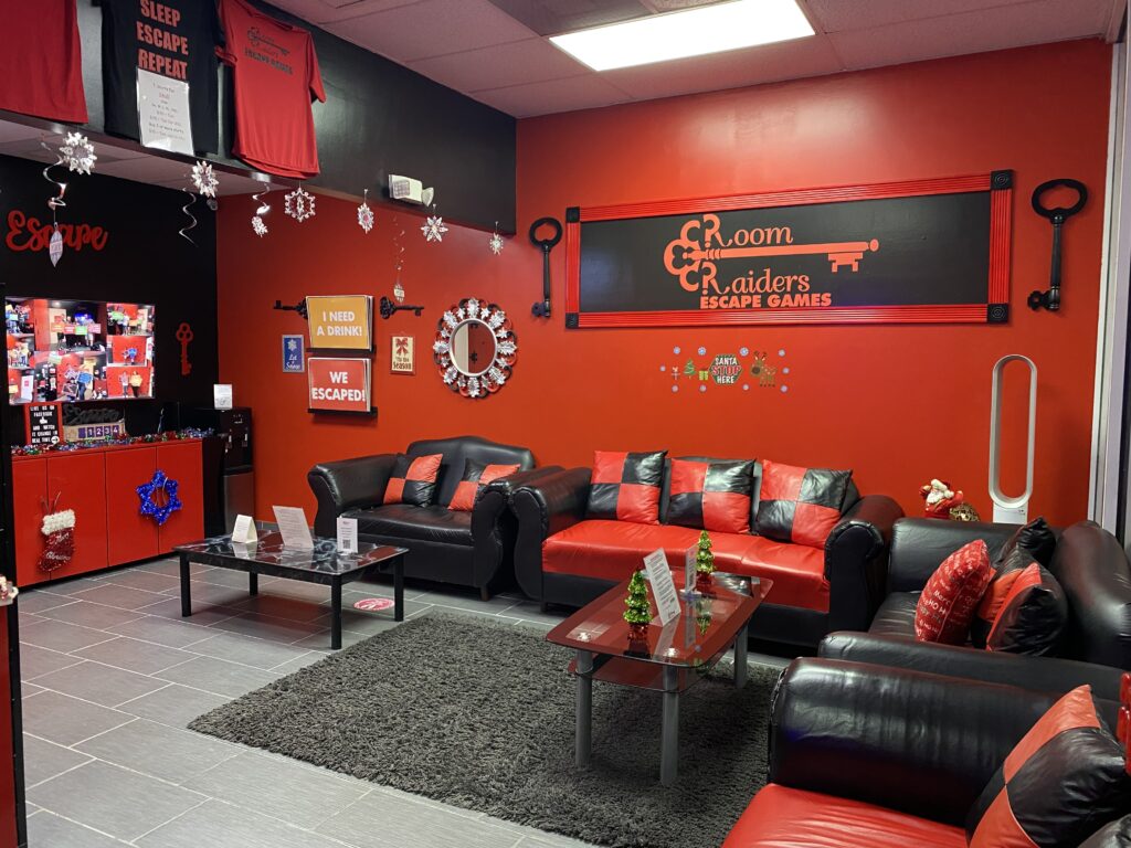 A room with red walls and black furniture.