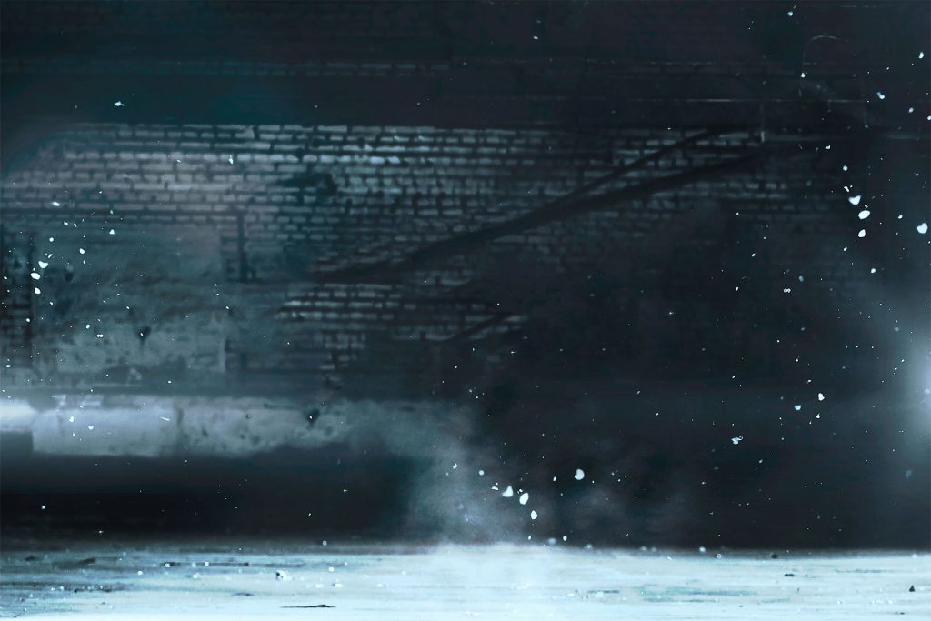 A dark room with smoke coming out of the ceiling.